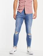 Asos Design Spray On Jeans With Power Stretch In Mid Wash With Rips-blues
