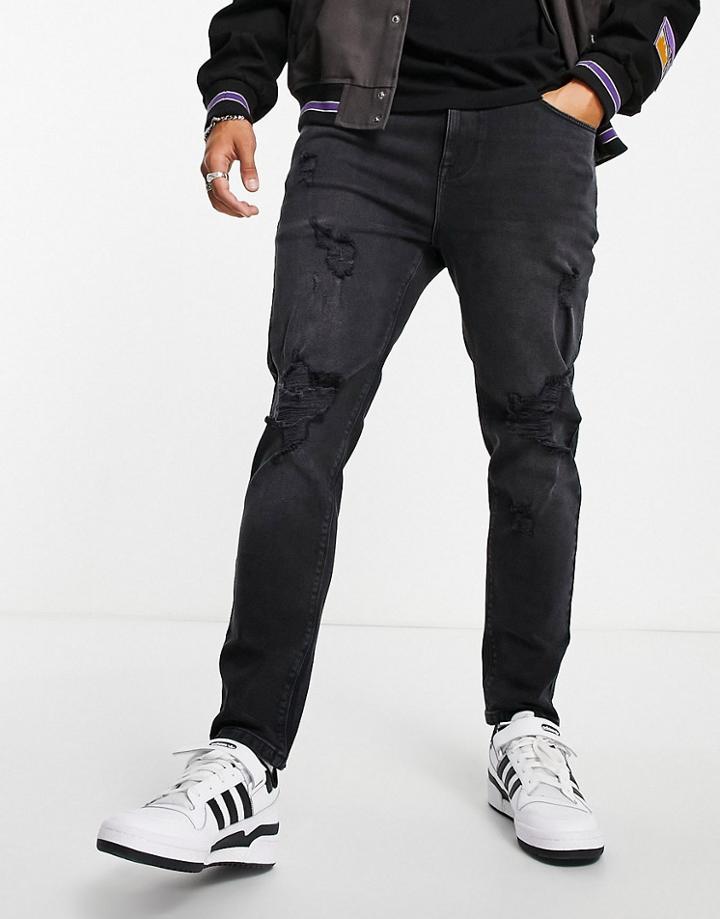 Asos Design Tapered Jeans In Washed Black With Heavy Rips