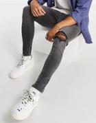 Asos Design Spray On Jeans With Power Stretch In Washed Black With Knee Rip And Abrasions