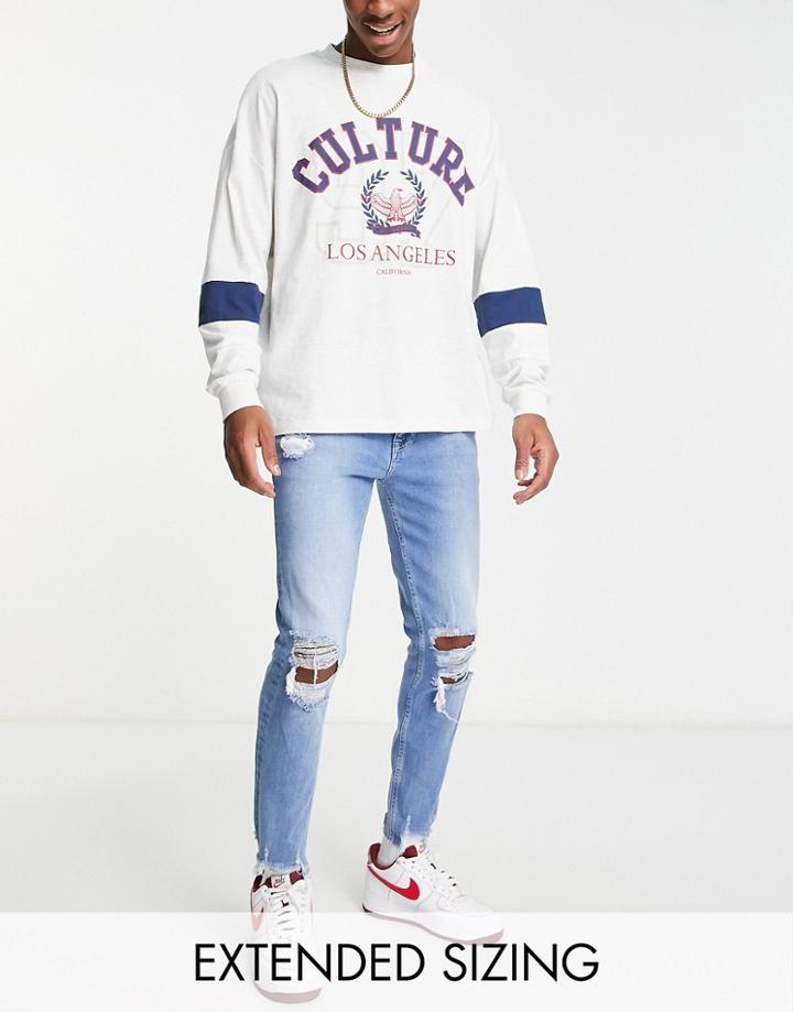 Asos Design Skinny Jeans In Mid Blue With Heavy Knee Rips