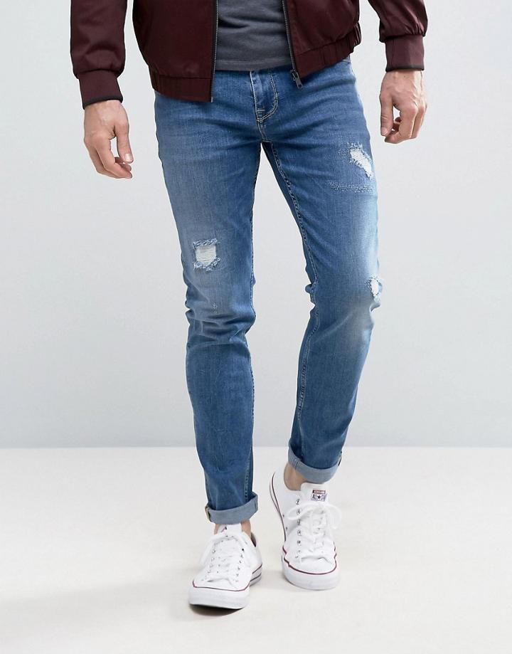 Asos Skinny Jeans In Mid Blue With Rip & Repair Detail - Blue