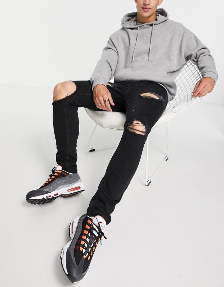 Asos Design Skinny Jeans In Washed Black With Heavy Rips And Raw Hem