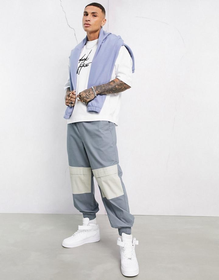Asos Dark Future Oversized Tapered Pants With Contrast Panels And Embroidery-blues