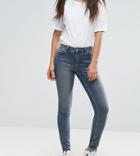 Asos Tall Lisbon Skinny Mid Rise Jeans In Dita Tinted Mid Wash With Reverse Stepped Hem-blue