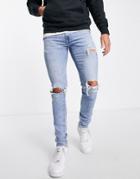Levi's Skinny Taper Jeans In Light Blue Wash With Knee Rips