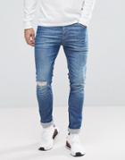 Asos Super Skinny Jeans In Mid Wash Blue With Rip And Repair - Blue