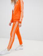 Adidas Originals Three Stripe Cigarette Pants In Orange - Orange
