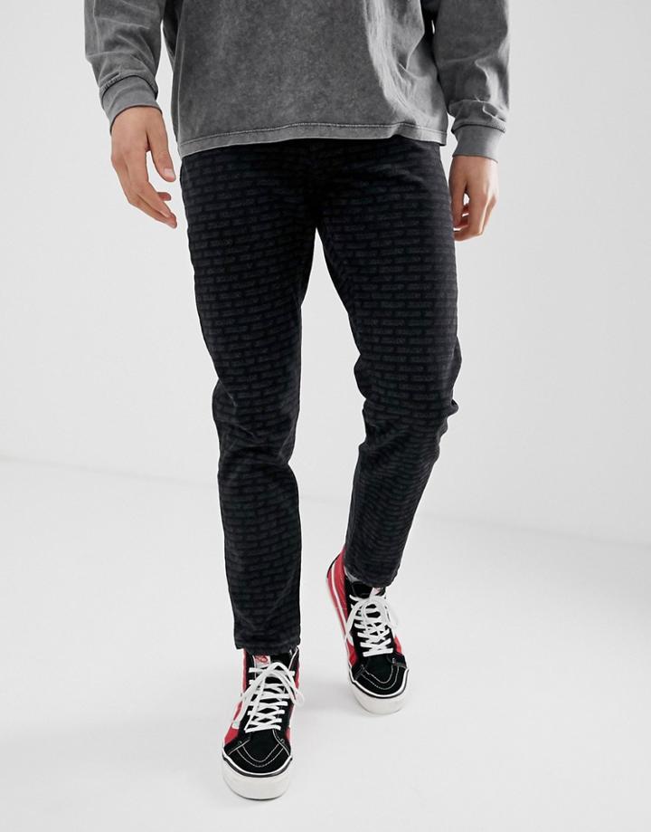 Asos Design Tapered Jeans With All Over Print In Black