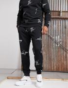 Asos Design Two-piece Tapered Sweatpants With All Over Dark Future Logo Print In Black
