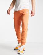 Nike Club Loose Fit Cuffed Sweatpants In Orange