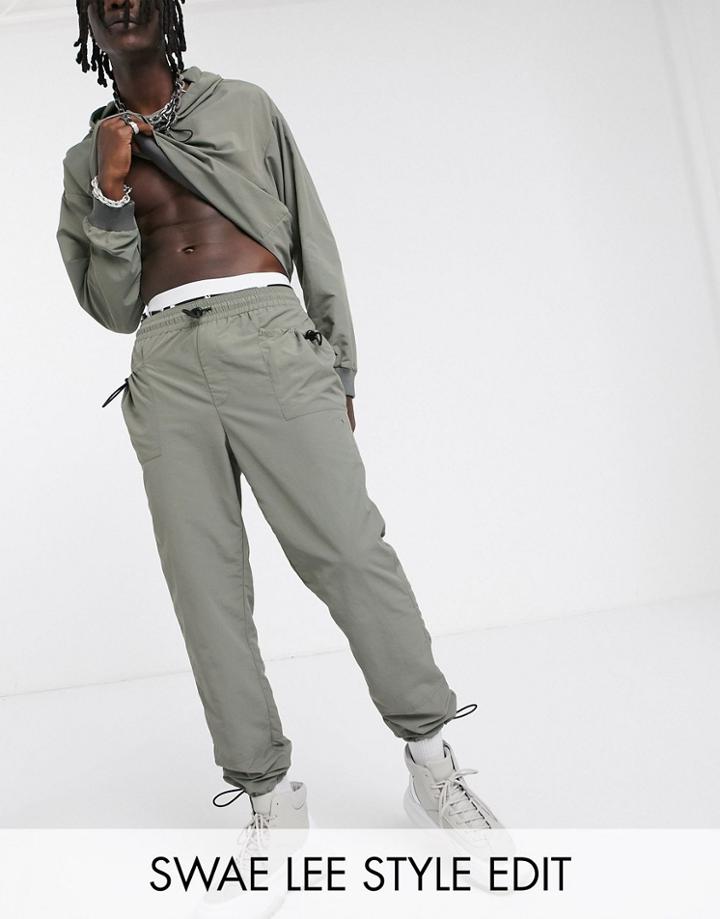 Asos Design Two-piece Tapered Pants In Nylon With Toggle Detail At Pockets And Cuff