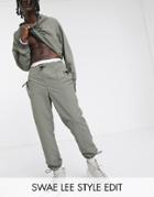 Asos Design Two-piece Tapered Pants In Nylon With Toggle Detail At Pockets And Cuff