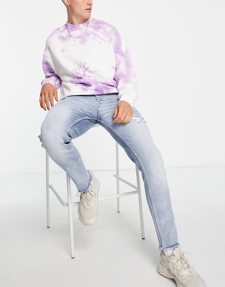 Asos Design Skinny Jeans In Dusty Blue Wash With Abrasions And Raw Hem-blues
