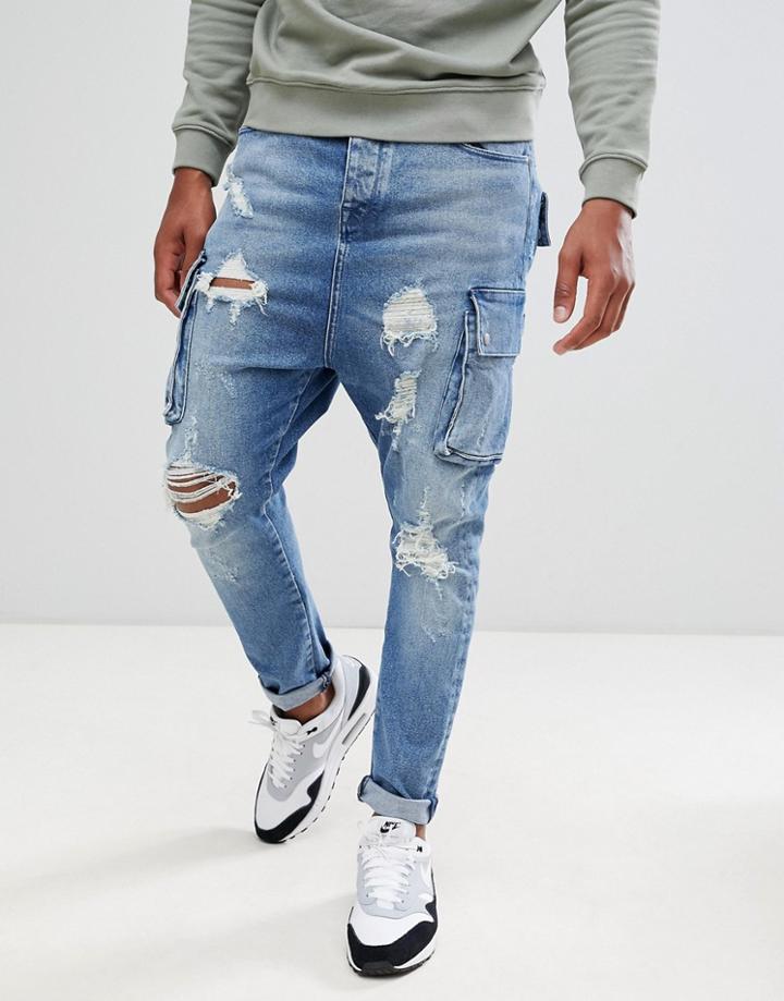 Asos Design Drop Crotch Jeans In Mid Wash Blue With Cargo Pockets And Rips