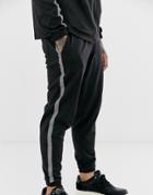 Asos Design Two-piece Tapered Sweatpants In Poly Tricot With Reflective Tape In Black - Black