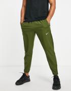 Nike Running Dri-fit Challenger Woven Pants In Khaki-green