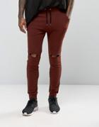 Asos Super Skinny Joggers With Knee Rips In Dark Red - Red