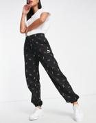 Puma Classics All Over Logo Print Sweatpants In Black And Gold