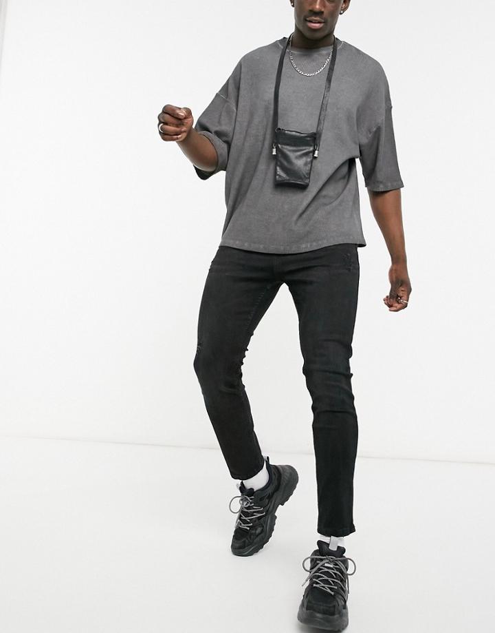 Pull & Bear Carrot Fit Jeans With Rips In Washed Black