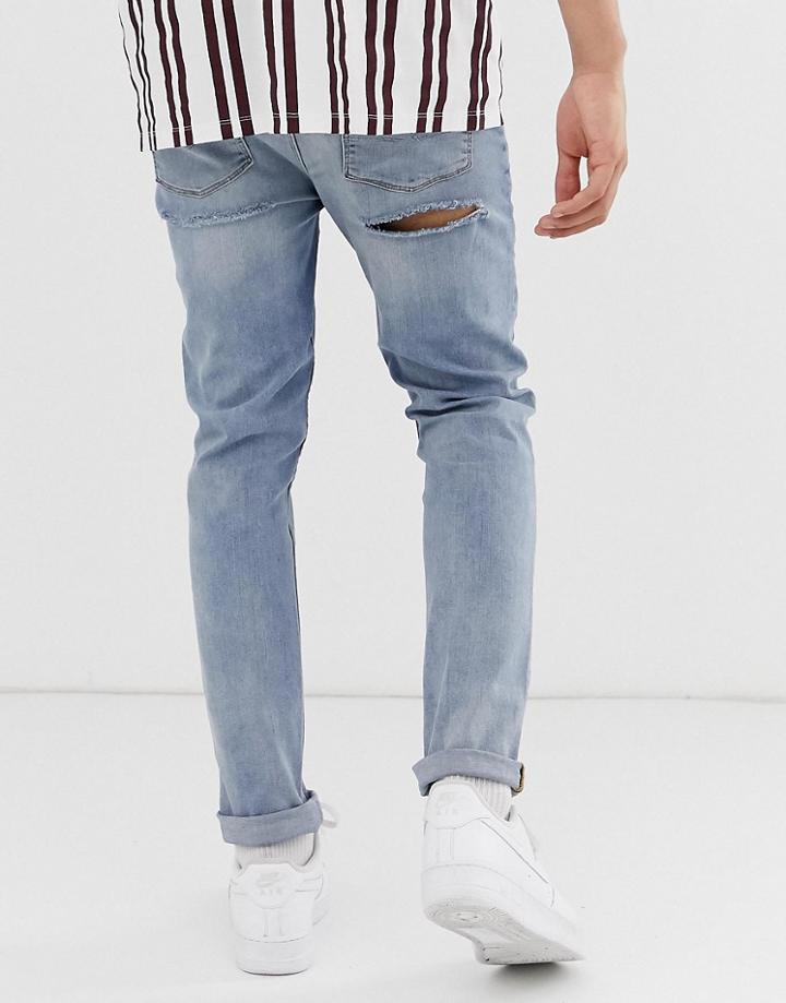 Asos Design Skinny Jeans In Mid Wash Blue With Bum Rips - Blue