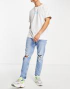 Asos Design Tapered Carrot Jeans In Light Wash Blue With Knee Rips-blues