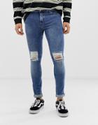 Asos Design Super Skinny Jeans In 12.5oz Mid Wash Blue With Knee Rips