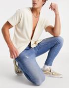 Asos Design Spray On Jeans With Power Stretch In Mid Wash With Abrasions-blues
