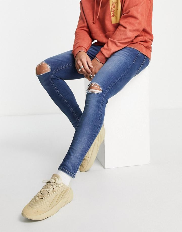 Asos Design Spray On Jeans With Power Stretch In Dark Wash Blue With Knee Rips-blues