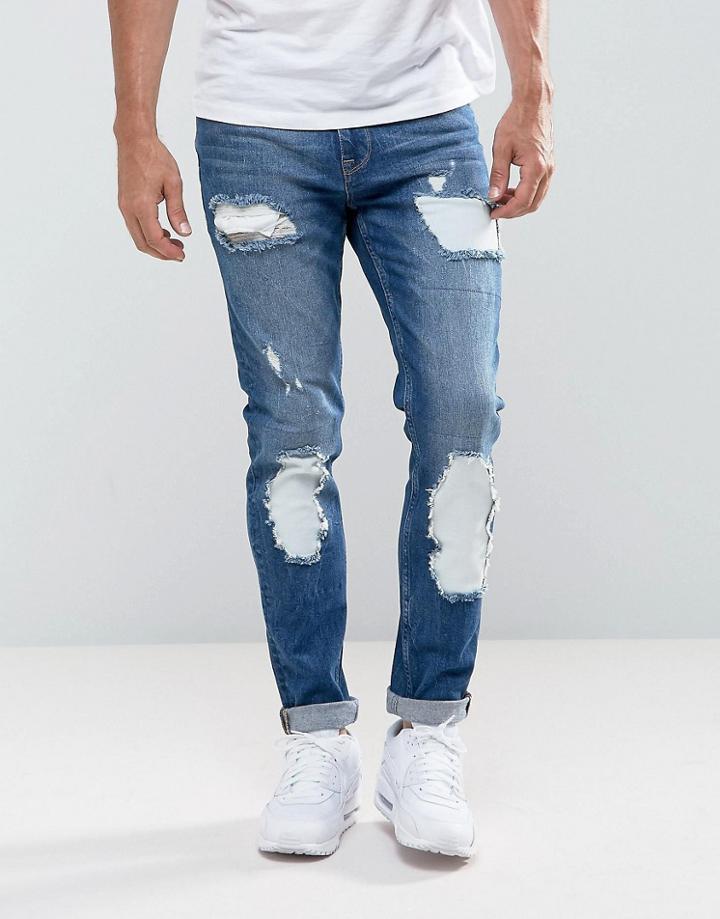 Asos Skinny Jeans In Mid Wash Blue With Rip And Repair - Blue