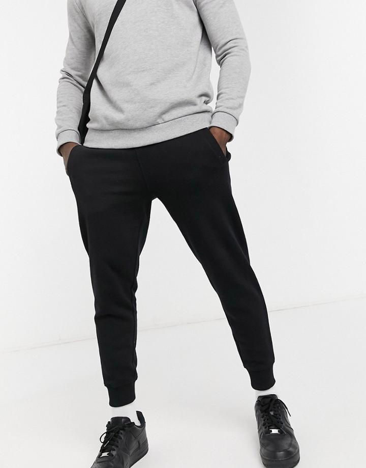 Guess Skinny Cuffed Sweatpants In Black With Small Logo