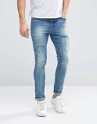 Asos Super Skinny Jeans With Patches And Abrasions In Mid Blue - Mid Blue