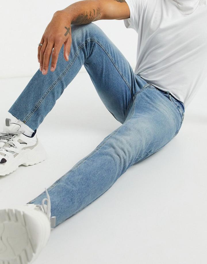 Asos Design Slim Jeans In Tinted Mid Wash Blue With Raw Hem