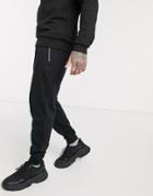 Asos Design Organic Tapered Sweatpants In Black With Silver Zip Pockets