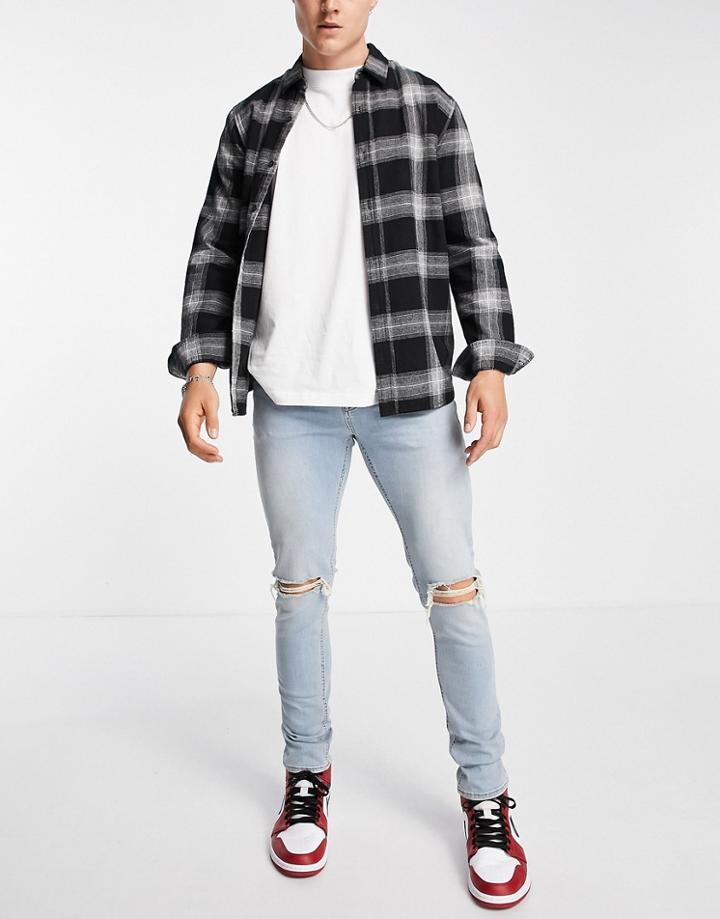 Asos Design Skinny Jeans In Tinted Light Wash With Knee Rips-blues