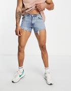 Asos Design Denim Shorts In 90s Mid Wash With Rip Detail And Raw Hem In Shorter Length-blue