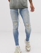 The Couture Club Skinny Jeans With Knee Logo And Rips In Mid Wash Blue - Blue