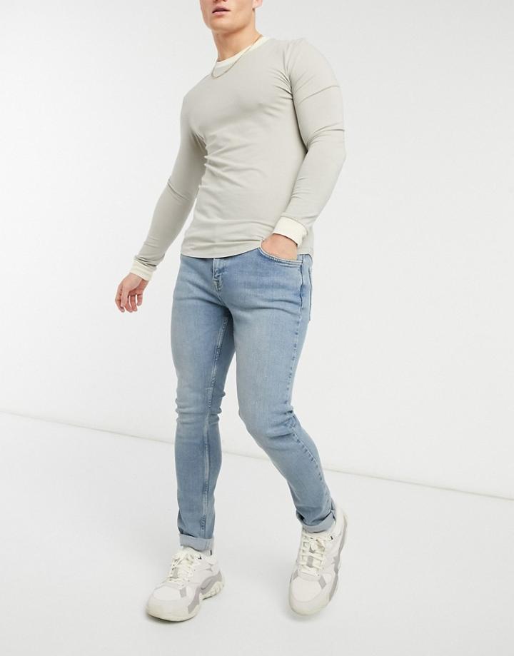 Asos Design Skinny Jeans In Vintage Look Tinted Light Wash-blue