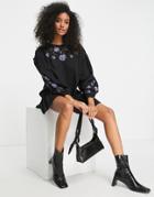Asos Design Mini Smock Dress With Frill Seams And Purple Floral Embroidery In Black