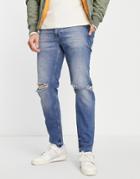 Asos Design Tapered Jeans In Mid Tinted Wash With Knee Rips And Destroyed Hem-blue