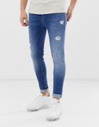 Asos Design Spray On Jeans With Power Stretch In Mid Wash Blue With Abrasions - Blue