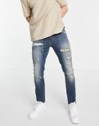 Asos Design Skinny Jeans With Heavy Rips And Raw Hem In Tinted Mid Wash-blues