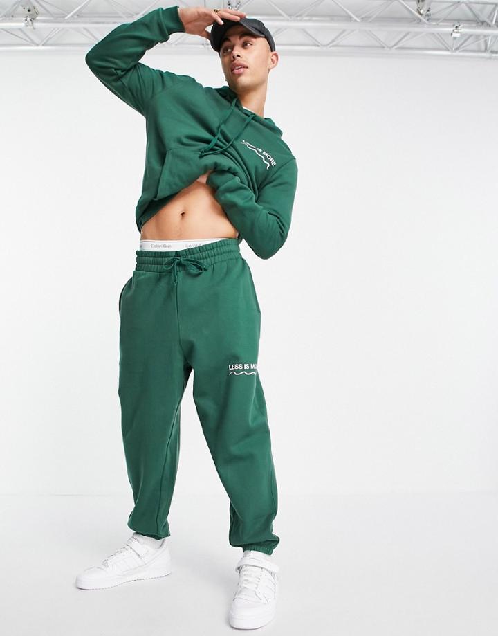 Asos Design Oversized Sweatpants In Dark Green With Wellness Text Print - Part Of A Set