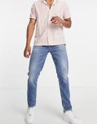 Asos Design Organic Cotton Blend Tapered Jeans In Mid Wash Blue-blues