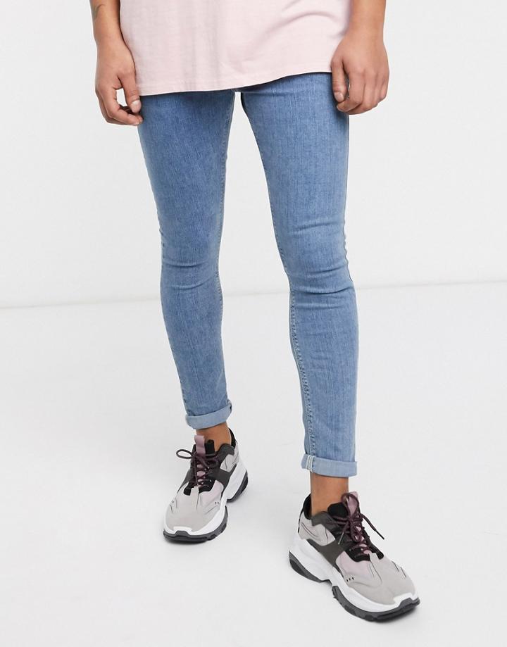 Asos Design Spray On Jeans In Power Stretch Denim In Light Wash Blue