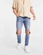Asos Design Skinny Jeans With Knee Rips And Destroyed Hem In Mid Wash Blue-blues