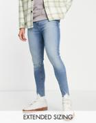 Asos Design Spray-on Jeans In Power Stretch In Light Wash With Ripped Hem Detail-blue