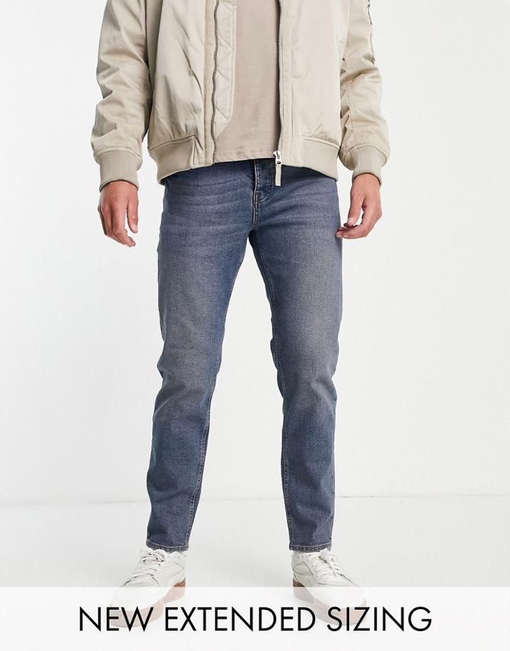 Asos Design Stretch Tapered Jeans In Tinted Mid Wash-blues