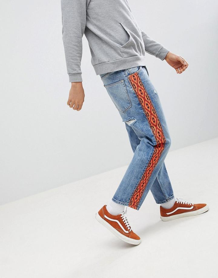 Asos Design Skater Jeans In Vintage Mid Wash With Orange Geo-tribal Side Stripe - Blue