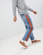 Asos Design Skater Jeans In Vintage Mid Wash With Orange Geo-tribal Side Stripe - Blue