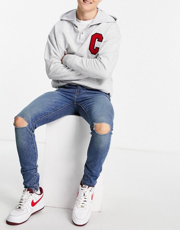 Levi's Skinny Tapered Fit Jeans In Blue Wash With Knee Rips-blues